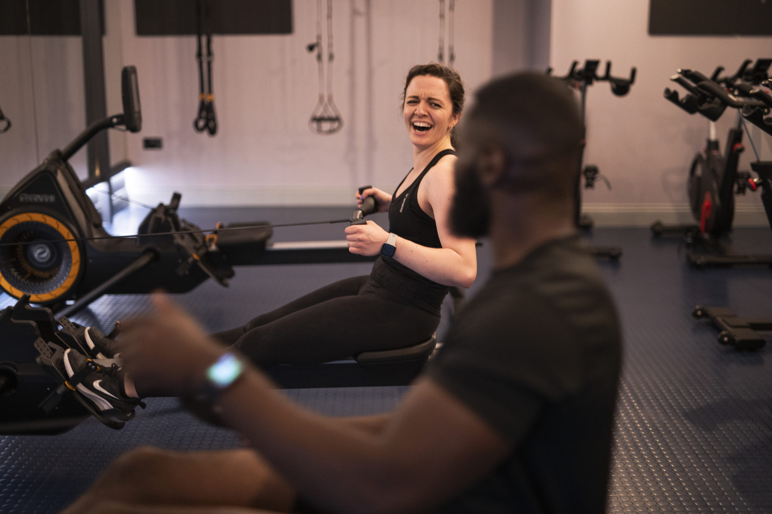male and female on a rower participating in a HIIT class based in London, Elephant and Castle